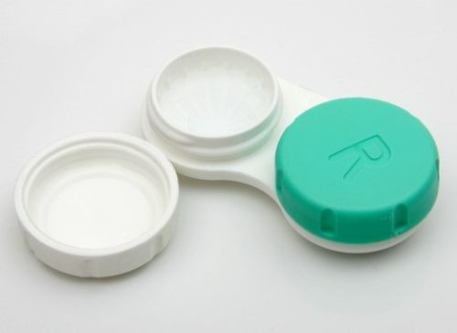 Open contact lens case with a white and green cap marked with an